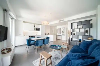 a living room with a blue couch and a table at Superb 55m2 apartment - Heart of Cannes - 2BR4p in Cannes