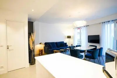 a living room with blue chairs and a table at Superb 55m2 apartment - Heart of Cannes - 2BR4p in Cannes