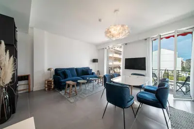 a living room with blue chairs and a table at Superb 55m2 apartment - Heart of Cannes - 2BR4p in Cannes
