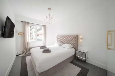 a bedroom with a white bed and a window at Superb 55m2 apartment - Heart of Cannes - 2BR4p in Cannes