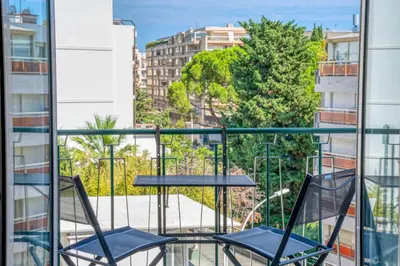 two chairs on a balcony with a view of a city at Superb 55m2 apartment - Heart of Cannes - 2BR4p in Cannes