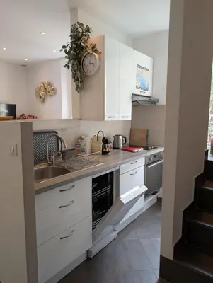 a kitchen with white cabinets and a sink at Appartement - Cannes vieille ville - Le Suquet in Cannes