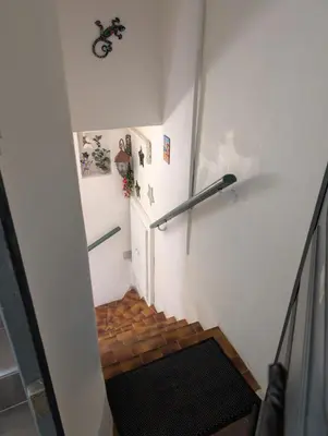 a stairway with a railing on the side of a room at Appartement - Cannes vieille ville - Le Suquet in Cannes