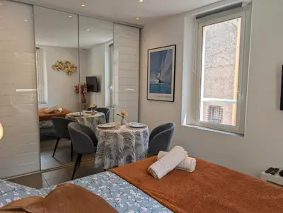 a room with a table and chairs and a dining room at Appartement - Cannes vieille ville - Le Suquet in Cannes