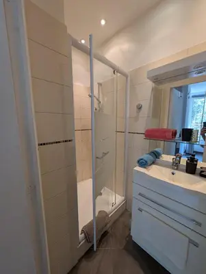 a bathroom with a shower and a sink and a mirror at Appartement - Cannes vieille ville - Le Suquet in Cannes