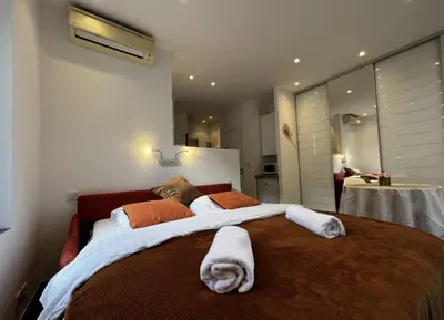 a bedroom with a large bed with towels on it at Appartement - Cannes vieille ville - Le Suquet in Cannes