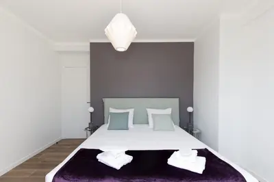 a bedroom with a bed with a purple rug at Wam YourHostHelper in Cannes