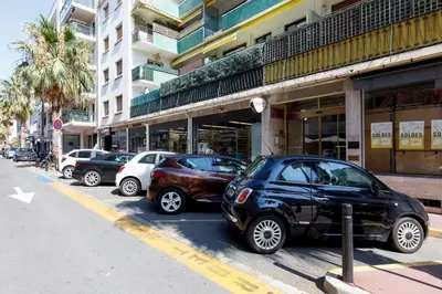 a row of parked cars parked in front of a building at Wam YourHostHelper in Cannes