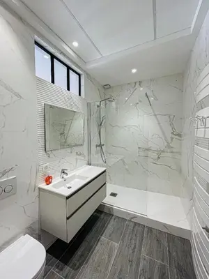 a white bathroom with a sink and a toilet at cote sud deux chambres proche croisette in Cannes