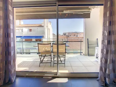a balcony with a table and chairs on a balcony at 3 Bedrooms, 3 bathrooms central Cannes Lecerf 411 in Cannes