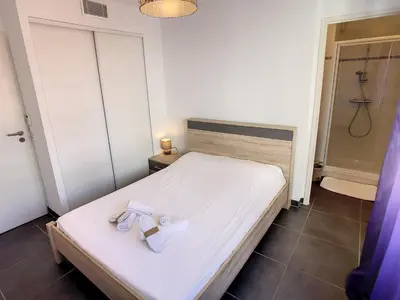 a bed with a pair of shoes sitting on it at 3 Bedrooms, 3 bathrooms central Cannes Lecerf 411 in Cannes