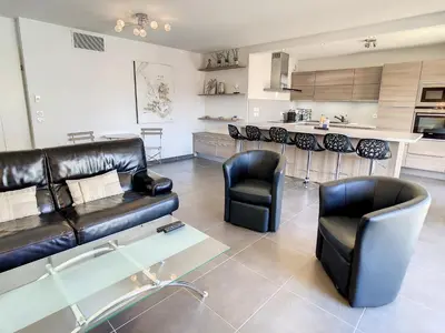 a living room with a black leather couch and chairs at 3 Bedrooms, 3 bathrooms central Cannes Lecerf 411 in Cannes