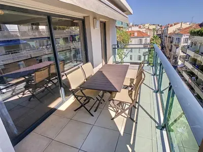 a balcony with a table and chairs on a balcony at 3 Bedrooms, 3 bathrooms central Cannes Lecerf 411 in Cannes