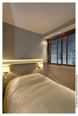 a bedroom with a bed with two lamps and a window at REF 761 - Cannes Croisette - Sea view apartment for rent in Cannes
