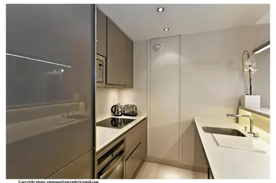 a white kitchen with a sink and a counter at REF 761 - Cannes Croisette - Sea view apartment for rent in Cannes