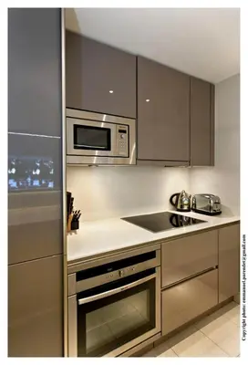 a kitchen with stainless steel appliances and a microwave at REF 761 - Cannes Croisette - Sea view apartment for rent in Cannes