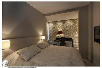 a bedroom with a large bed and a desk at REF 761 - Cannes Croisette - Sea view apartment for rent in Cannes