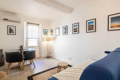 a living room with a blue couch and a table at Hé Jude le Suquet in Cannes