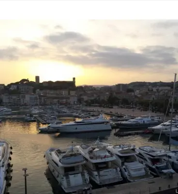 a group of boats are docked in a harbor at Hé Jude le Suquet in Cannes