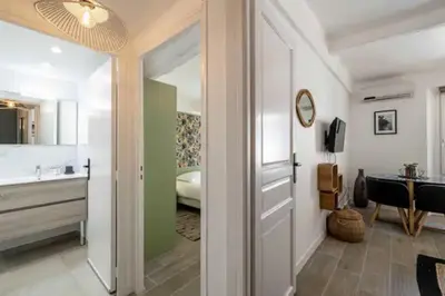 a bathroom with a door leading to a bedroom at Hé Jude le Suquet in Cannes