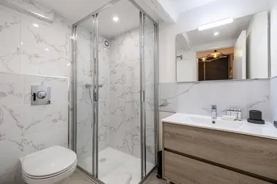 a bathroom with a shower and a toilet and a sink at Hé Jude le Suquet in Cannes