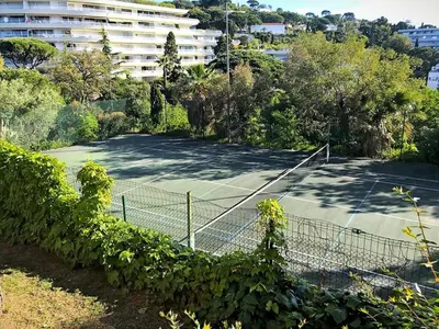 a tennis court in front of a building at Cannes Villa Francia in Cannes