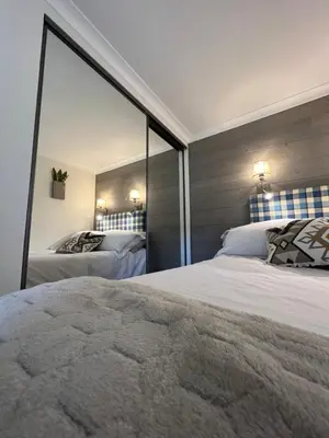 a bedroom with two beds and a large mirror at Cannes Villa Francia in Cannes