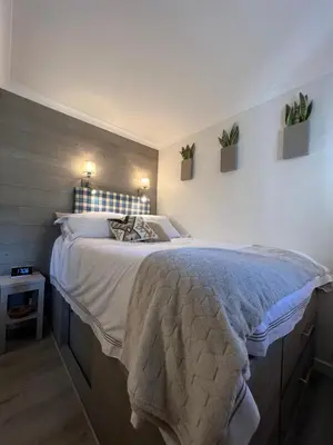 a bedroom with a large bed with two plants on the wall at Cannes Villa Francia in Cannes