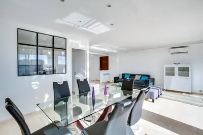 a dining room with a glass table and chairs at Appartement Alexandre lumineux avec superbe vue mer in Cannes