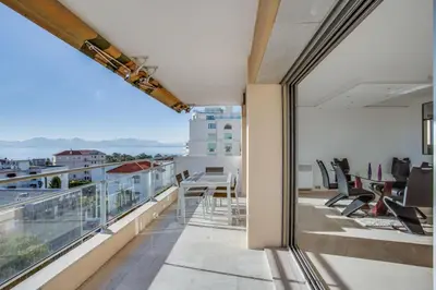a balcony with a table and chairs on a building at Appartement Alexandre lumineux avec superbe vue mer in Cannes