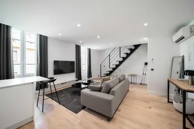 a living room with a couch and a tv at Charming apartment for 4 people - Forville Market in Cannes