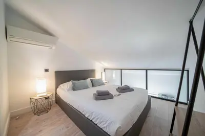 a bedroom with a large bed with two towels on it at Charming apartment for 4 people - Forville Market in Cannes