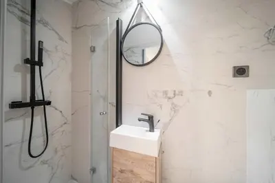a bathroom with a sink and a mirror at Charming apartment for 4 people - Forville Market in Cannes