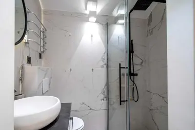 a bathroom with a sink and a glass shower at Charming apartment for 4 people - Forville Market in Cannes