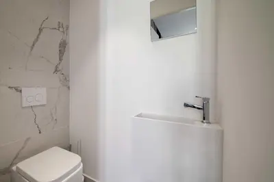 a bathroom with a white toilet and a sink at Charming apartment for 4 people - Forville Market in Cannes