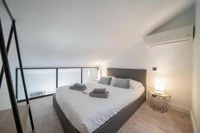 a bedroom with a large bed with two pillows on it at Charming apartment for 4 people - Forville Market in Cannes