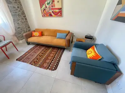 a living room with two couches and a rug at Sunset by Connexion in Cannes