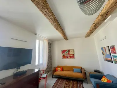 a living room with a couch and a flat screen tv at Sunset by Connexion in Cannes
