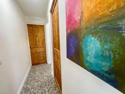 a painting hanging on a wall next to a door at Sunset by Connexion in Cannes