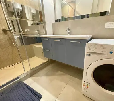 a bathroom with a washing machine and a sink at Sunset by Connexion in Cannes