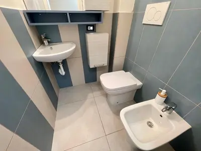 a small bathroom with a toilet and a sink at Sunset by Connexion in Cannes