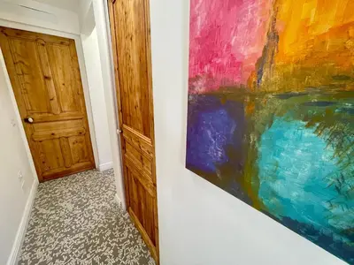 a painting hanging on a wall next to a door at Sunset by Connexion in Cannes
