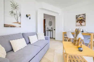 a living room with a couch and a table at Sublime Two bedroom apartment with Terrace in Cannes