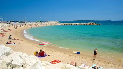 a group of people on a beach near the water at Sublime Two bedroom apartment with Terrace in Cannes