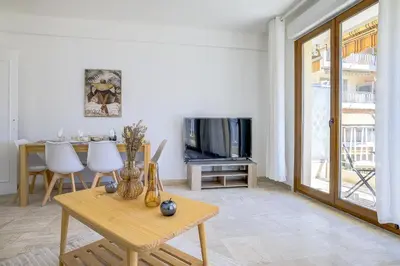 a living room with a table and a tv at Sublime Two bedroom apartment with Terrace in Cannes