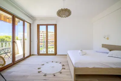 a bedroom with a bed and a balcony at Sublime Two bedroom apartment with Terrace in Cannes
