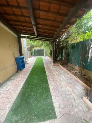 a walkway with a green lawn in front of a building at Superb Villa, heated swimming pool, central location, secluded gardens in Cannes