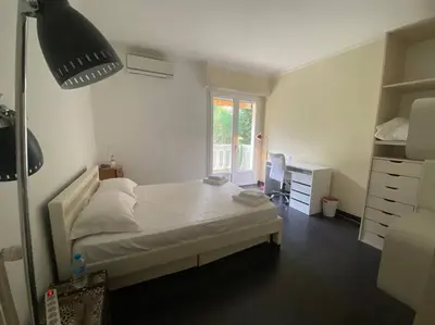 a bedroom with a white bed and a window at Superb Villa, heated swimming pool, central location, secluded gardens in Cannes