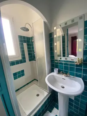 a bathroom with a sink and a shower at Superb Villa, heated swimming pool, central location, secluded gardens in Cannes