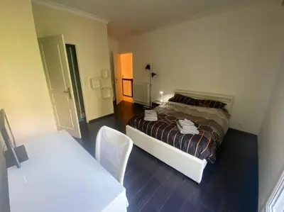 a bedroom with a bed and a table and chairs at Superb Villa, heated swimming pool, central location, secluded gardens in Cannes